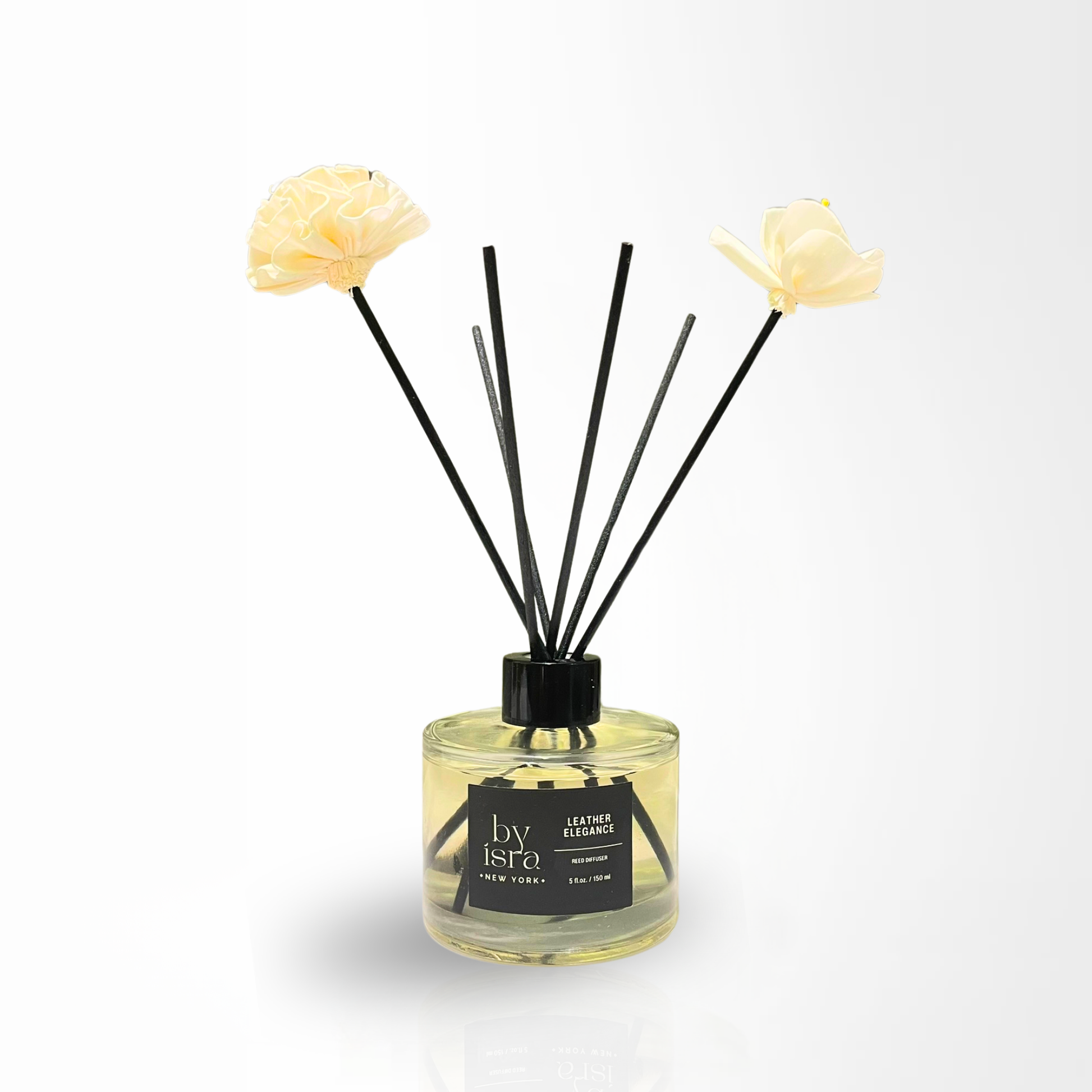 Reed diffuser with floral elements on a white background