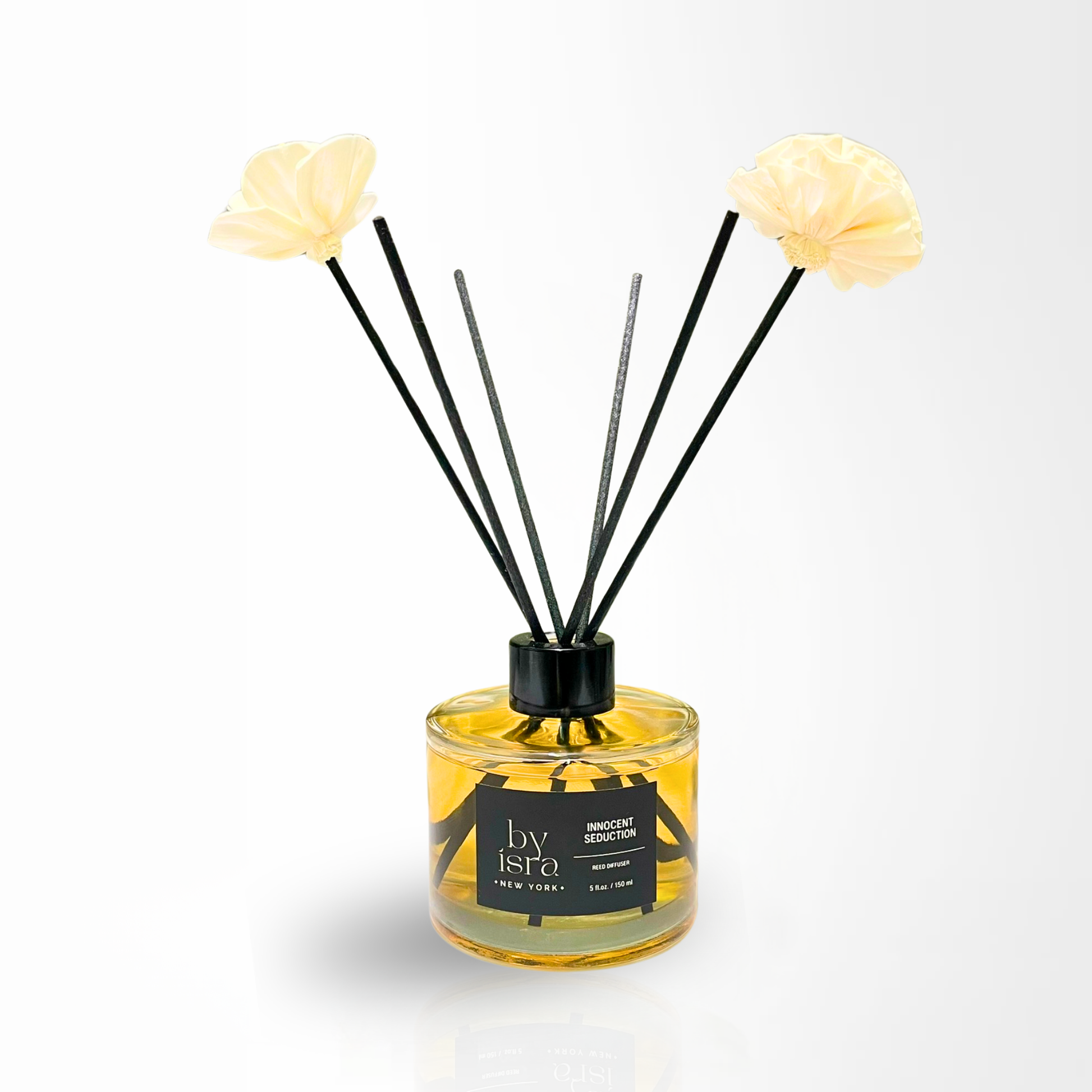 Reed diffuser with floral sticks in a glass bottle on a white background