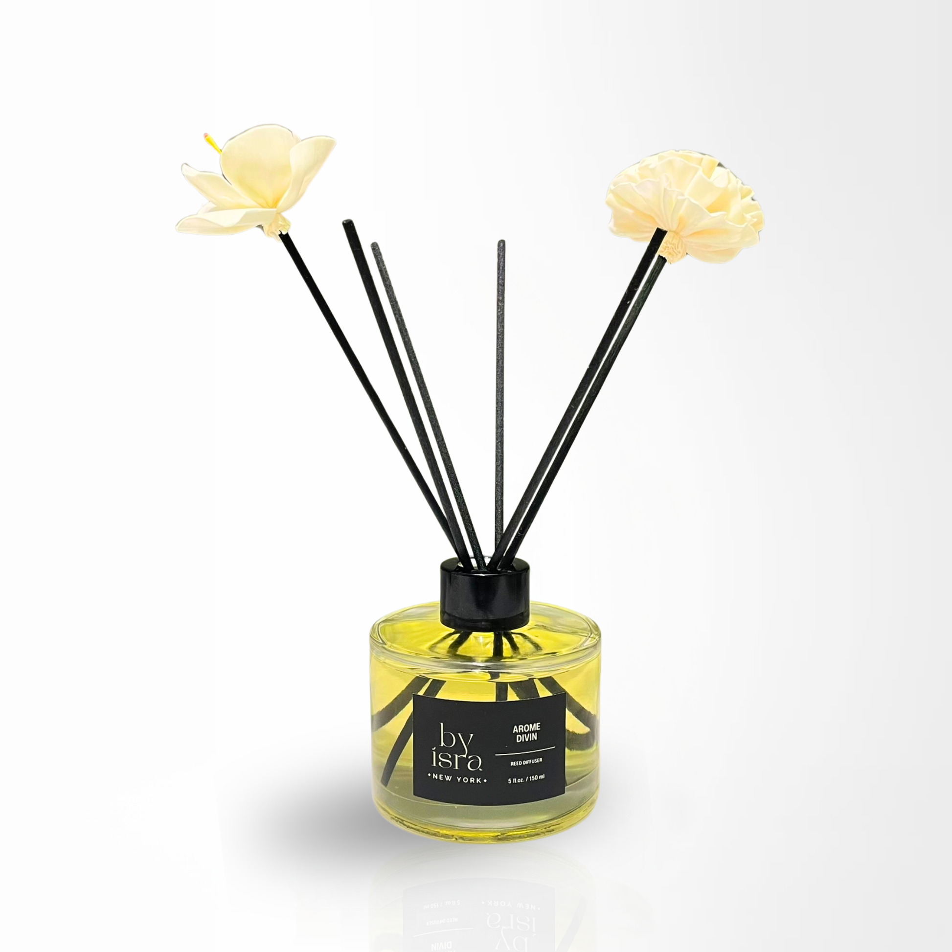 Reed diffuser with black sticks and yellow flowers on a white background