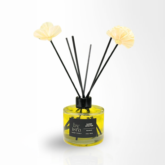 Reed diffuser with floral ends on a white background