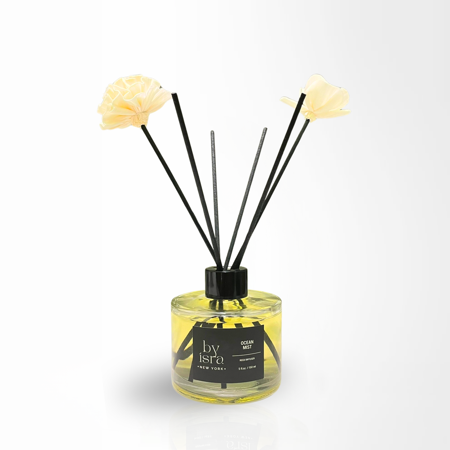 Reed diffuser with floral elements on a white background
